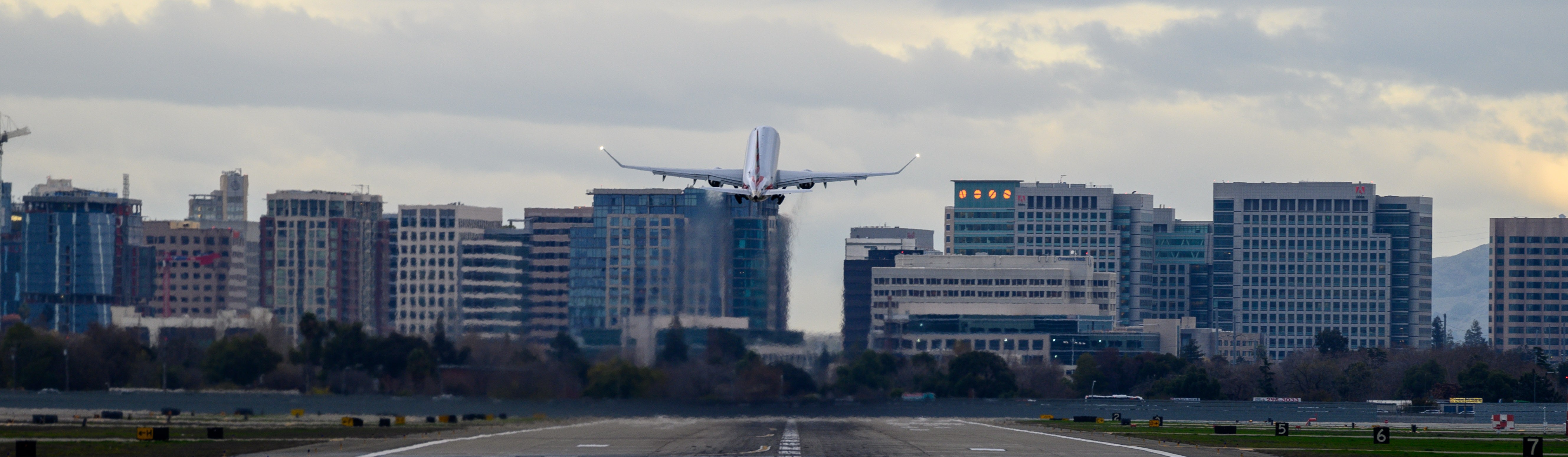 Plane with Downtown SJ skyline
