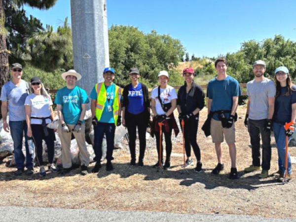 Airport employees and volunteers smile for a photo after cleaning up the river.