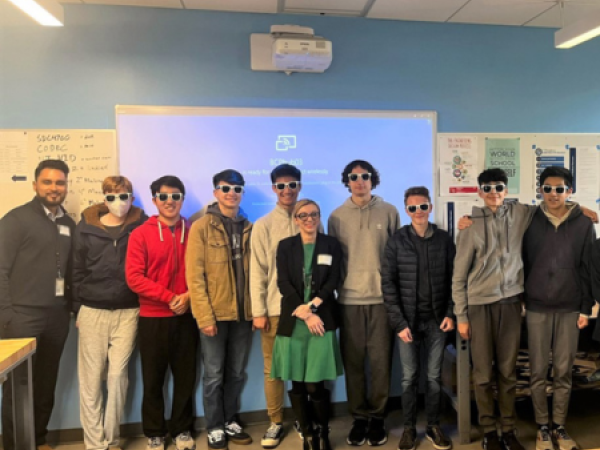 SJC employees and Bellarmine students smile for a photo together.